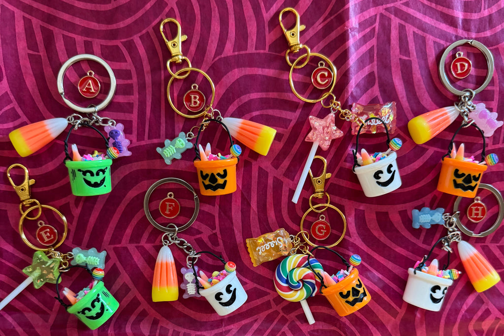 Collection of Halloween-themed keychains on a patterned background