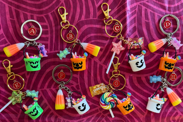Collection of Halloween-themed keychains on a patterned background